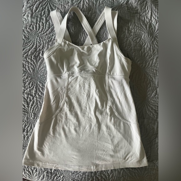 Lululemon white athletic top with detailing and pocket in the back. - Picture 1 of 4